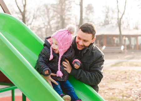 Happy child with father at the playground outdoorの写真素材