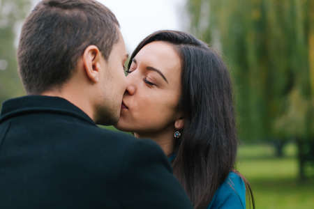 Concept of Valentines Day. Closeup of happy couple kissing outdoorの写真素材