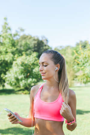 Runner woman listening music on her phone with copy spaceの写真素材