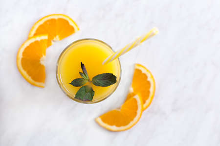 Fresh orange juice and orange with mintの写真素材