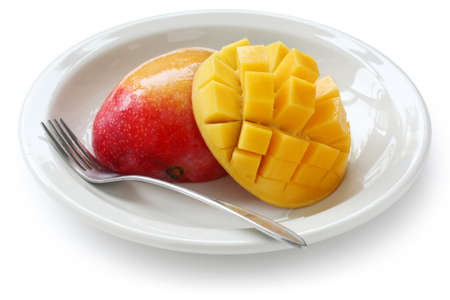 cube cut Mango on a white dishの写真素材