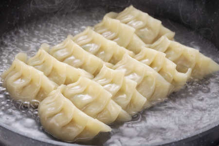 cooking gyoza dumplings, potstickers, japanese foodの写真素材