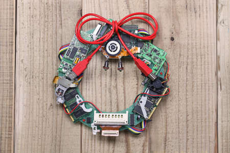 geeky christmas wreath made by old computer parts hanging on wooden door, computer parts recycling...
