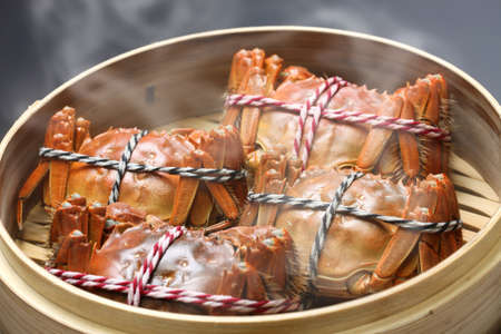 steaming shanghai hairy crabs in bamboo steamer, chinese cuisineの写真素材