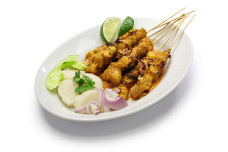 chicken satay with peanut sauce, indonesian skewer cuisine isolated on white backgroundの写真素材
