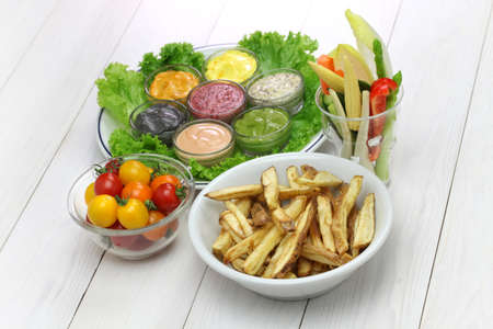 homemade assorted mayonnaise sauce with french fries and raw vegetablesの写真素材