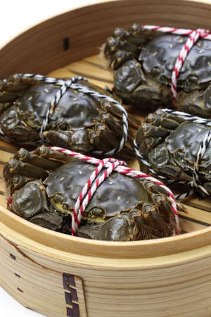 raw chinese mitten crab, shanghai hairy crab in bamboo steamerの写真素材