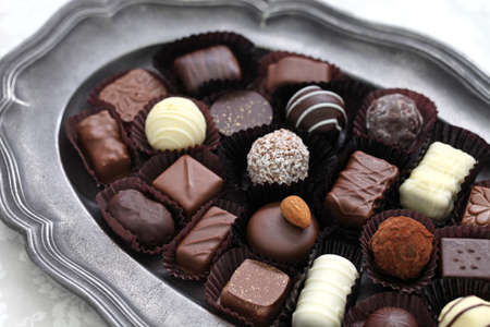 assorted chocolate on pewter dishの写真素材