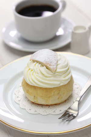 homemade semla, swedish sweet roll and cup of coffee