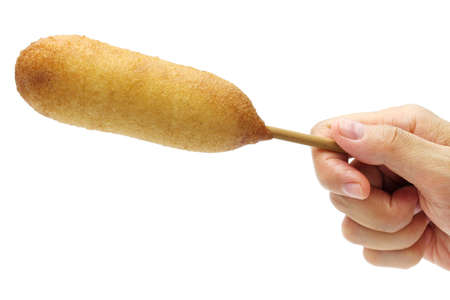 hand holding homemade corn dog isolated on white backgroundの写真素材