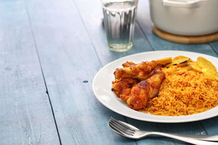 jollof rice with chicken and fried plantain, west african cuisineの写真素材