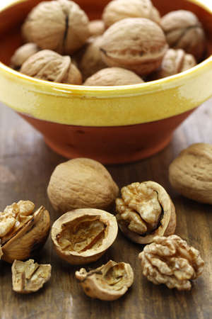 walnuts, kernel and shell on wooden background