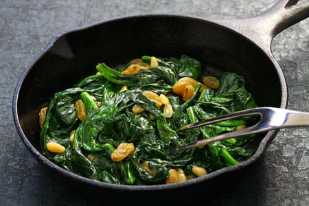 sauteed spinach with raisins and pine nuts, spanish catalan dishの写真素材