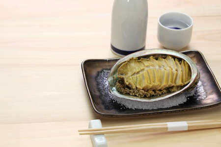 Steamed abalone with sakeの写真素材