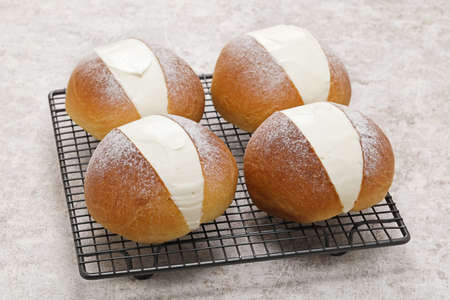homemade Maritozzo is italian roman breakfast sweet that whipped cream sandwiched between brioche.