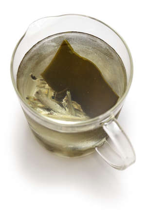 iriko( dried anchovy) and kombu (dried kelp) dashi, japanese basic soup stock in measuring cupの写真素材