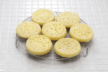 freshly baked crumpets cool on a cake cooler