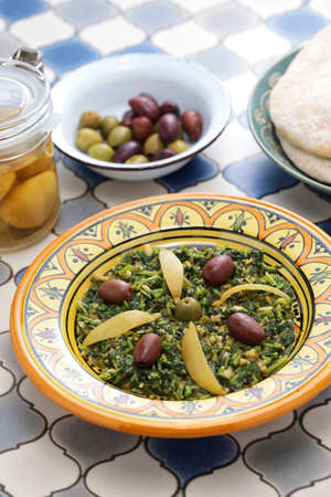 Moroccan mallow salad; the leaves are chopped, steamed and then sauteed with olive oil, spices, olives, and preserved lemons.の写真素材