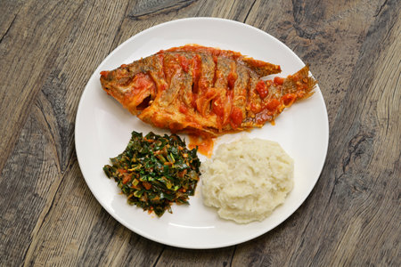 Tilapia stew, ugali(white maize flour mash) and Sukuma Wiki(kale stew), Kenyan foodの写真素材