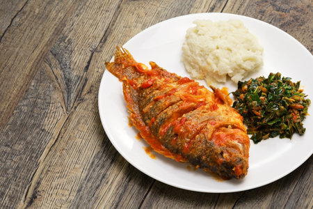 Tilapia stew, ugali(white maize flour mash) and Sukuma Wiki(kale stew), Kenyan foodの写真素材