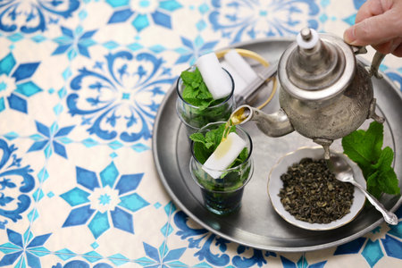 traditional Moroccan mint and sugar tea with a silver teapotの写真素材