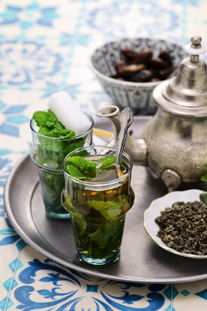 traditional Moroccan mint and sugar tea with a silver teapotの写真素材