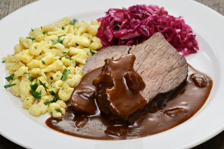 Sauerbraten (a German national dish, marinated braised beef) with Rotkohl (red cabbage), Spaetzle(small egg pasta)の写真素材