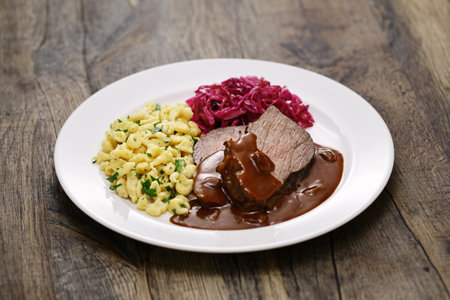 Sauerbraten (a German national dish, marinated braised beef) with Rotkohl (red cabbage), Spaetzle(small egg pasta)の写真素材