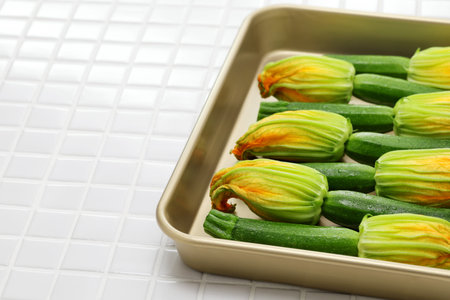 zucchini flowers in a tray, copy spaceの写真素材