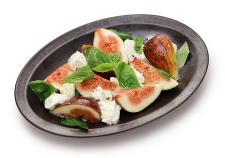 fig caprese salad(fig, mozzarella and basil) isolated on white backgroundの写真素材