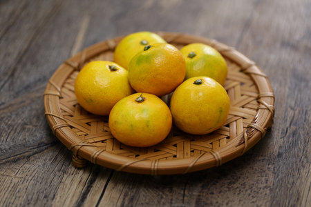 Japanese high-sugar high-quality mandarin oranges on a bamboo tray.の写真素材