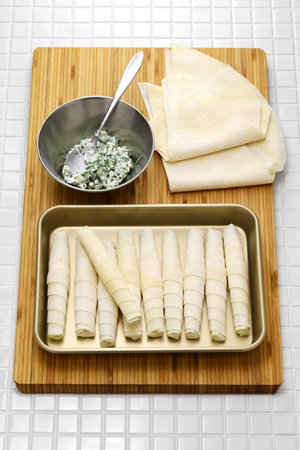 making Sigara borek, Cigar-like Turkish spring rolls.
A dough sheet called yufka wrapped with cheese filling and fried.の写真素材