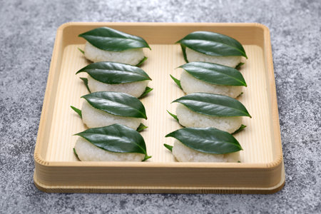 Tsubaki Mochi is Japan's oldest sweet. A glutinous rice cake filled with sweetened bean paste is sandwiched between two fresh camellia leaves.の写真素材