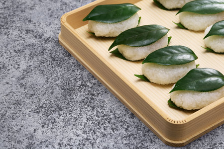 Tsubaki Mochi is Japan's oldest sweet. A glutinous rice cake filled with sweetened bean paste is sandwiched between two fresh camellia leaves.の写真素材