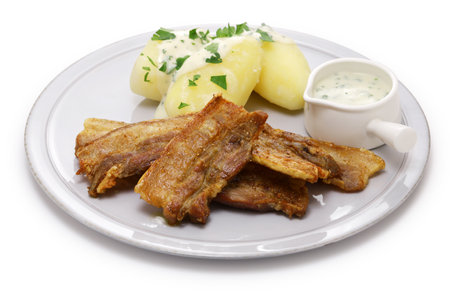"Stegt flÃ¦sk med persillesovs" (sliced pork belly with skin on and fried, served with parsley sauce and boiled potatoes). Denmark's national food.の写真素材