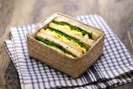 homemade coronation chicken sandwich in lunch box, British cuisineの写真素材