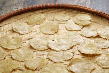 Emping, Indonesian crackers made from crushed Belinjo nuts. Drying on a bamboo tray.の写真素材