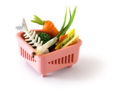 food waste (miniature) in a triangle sink garbage strainer, A visual emphasizing household food waste.の写真素材