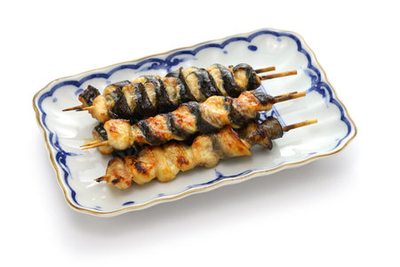 Kurikara-yaki (charcoal grilled eel skewers), Japanese unagi dish isolated on white backgroundの写真素材