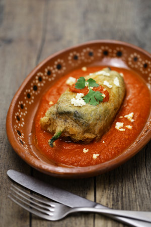 chile relleno (fried poblano pepper stuffed with minced meat and coated with egg meringue), Mexican cuisineの写真素材