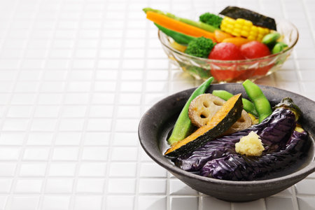 Cold appetizer for summer. Lightly boiled or fried vegetables and then soaked in stock broth.の写真素材