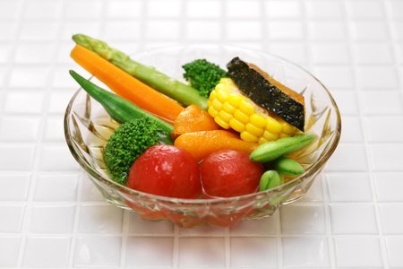 Cold appetizer for summer. Lightly boiled or fried vegetables and then soaked in stock broth.の写真素材