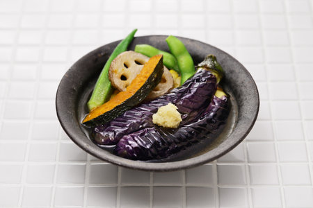 Cold appetizer for summer. Lightly boiled or fried vegetables and then soaked in stock broth.の写真素材