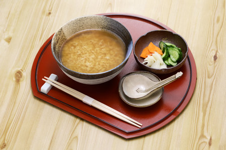 Nara Chagayu (tea porridge in Nara) is made by cooking cold rice in boiled hojicha (roasted green tea). With tsukemono pickles. Japanese breakfast.の写真素材