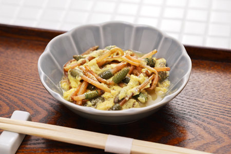 Japanese wild vegetable dish in spring. Tsukushi ( Field Horsetail ) simmered for a bit, and then added beaten eggs.の写真素材
