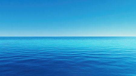 A stunning view of a calm ocean surface under a clear blue sky, evoking feelings of peace and tranquility, ideal for relaxation, nature themes, or travel projects.の素材