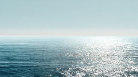 A stunning view of an endless ocean under a clear sky, showcasing gentle waves and shimmering light reflecting off the calm water surface.の素材