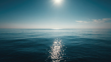 Stunning view of a calm ocean under a bright sky, showcasing shimmering reflections on the water's surface, perfect for serenity and relaxation.の素材