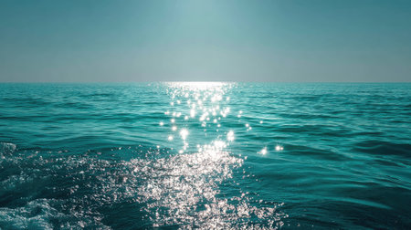 A stunning seascape capturing the beauty of sunlight reflecting on calm ocean waters. The tranquil blue tones create a serene atmosphere perfect for relaxation.の素材