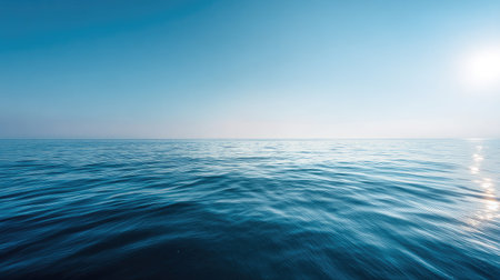 A peaceful view of the ocean's surface under a clear blue sky, showcasing gentle waves and a serene atmosphere. Ideal for relaxation and travel themes.の素材
